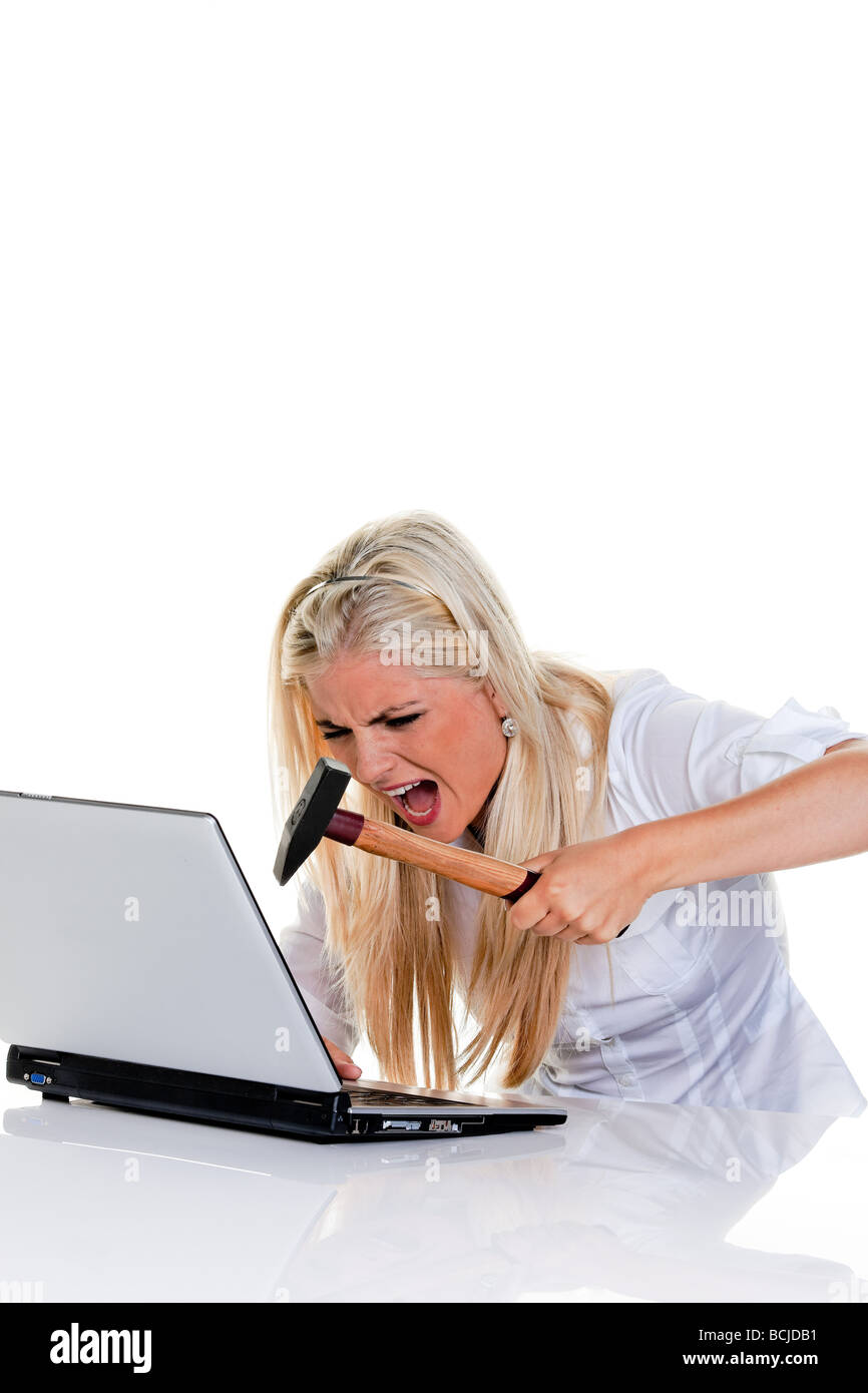 woman has problems with computer; hammer and laptop Stock Photo