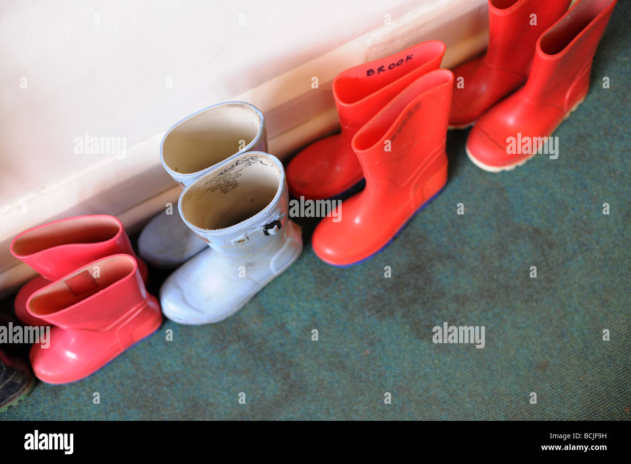 childrens wellington boots in line Stock Photo - Alamy