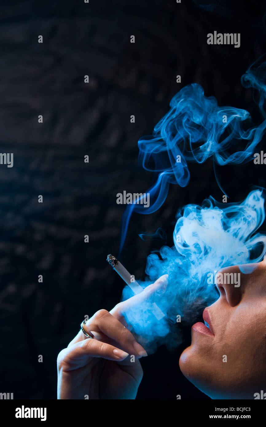 A woman with a smoking cigarette Stock Photo