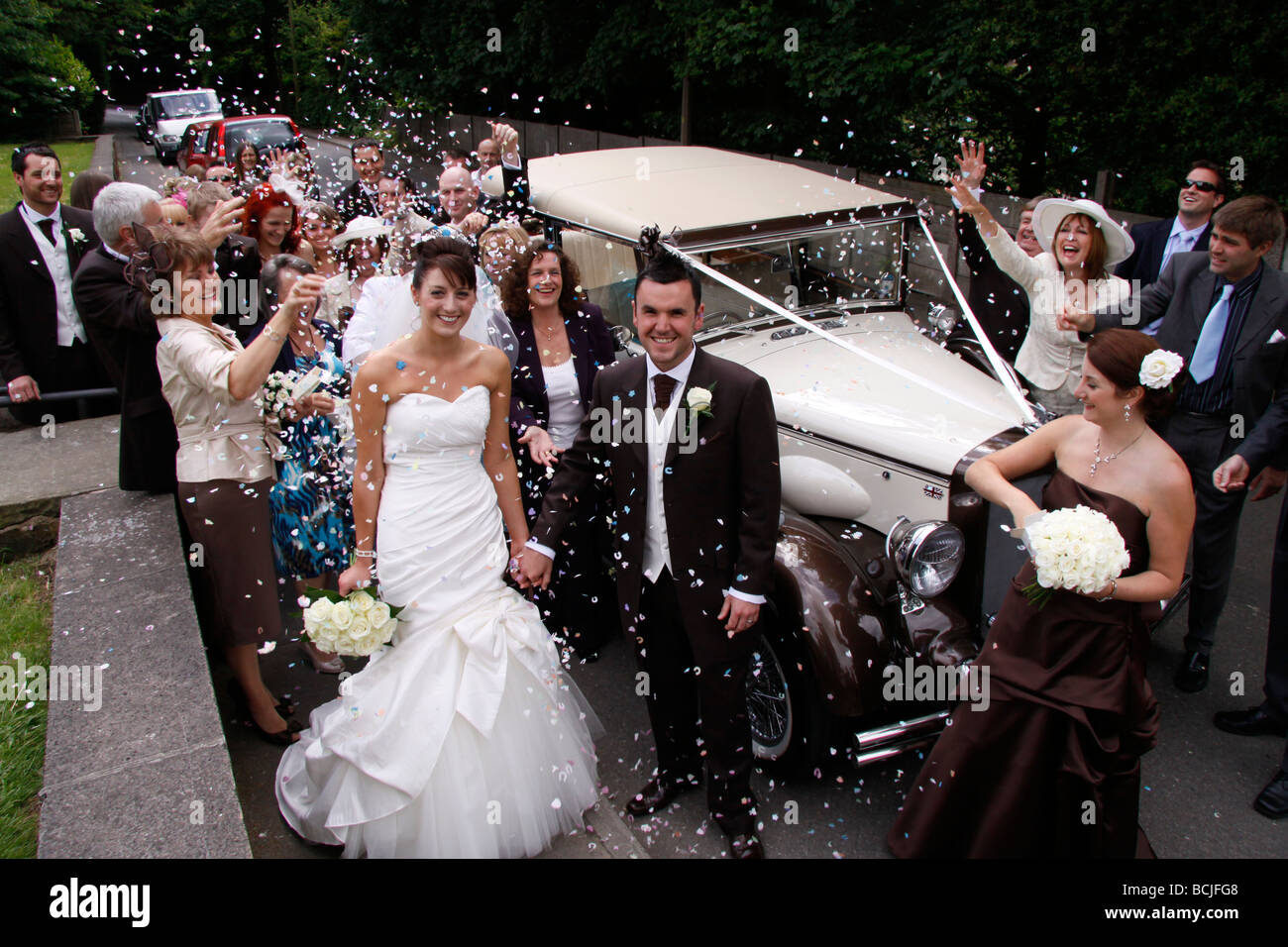 Bride and Groom with guests throwing confetti Stock Photo Alamy
