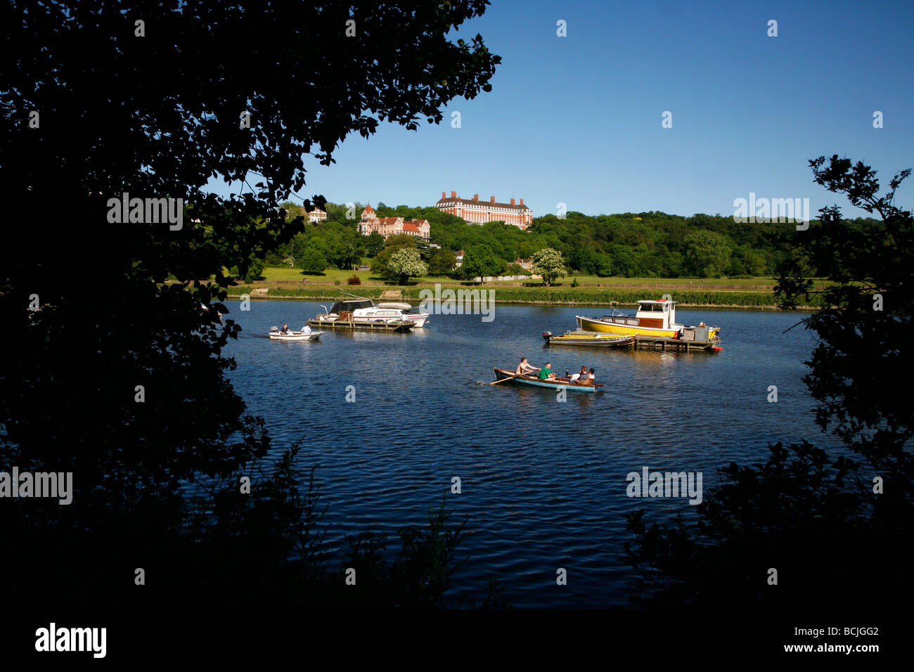 Looking across the River Thames to Petersham Meadows and the Star and Garter Home on Richmond Hill, Richmond, London, UK Stock Photo