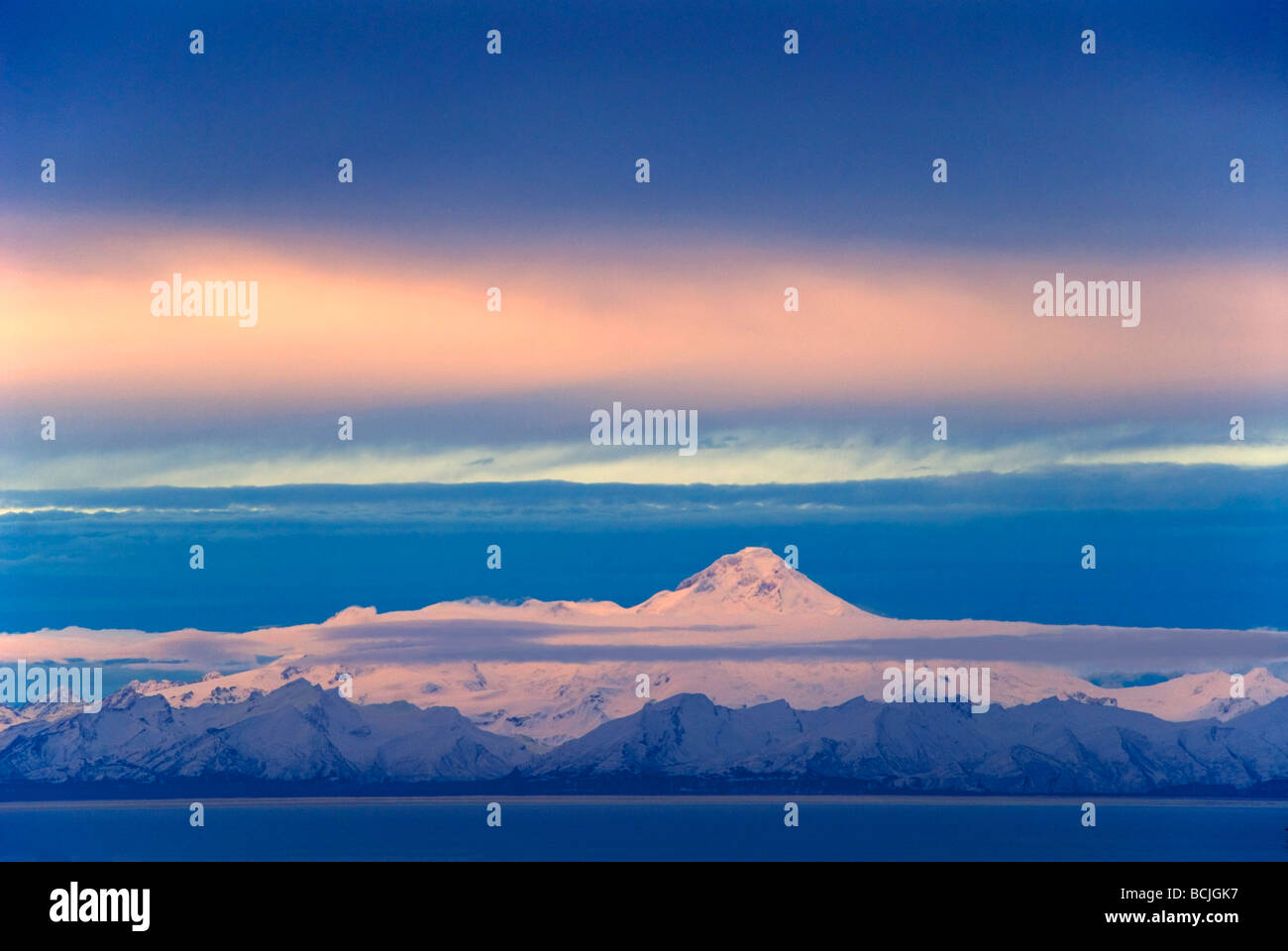 Iliamna Volcano seen across Cook Inlet from the Kenai Peninsula in Southcentral Alaska during Winter Stock Photo