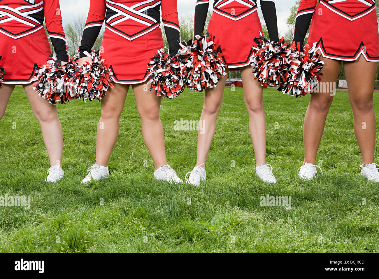 Cheerleaders with pom poms Stock Photo
