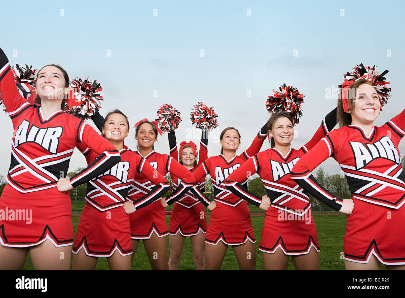 Cheerleaders performing routine Stock Photo
