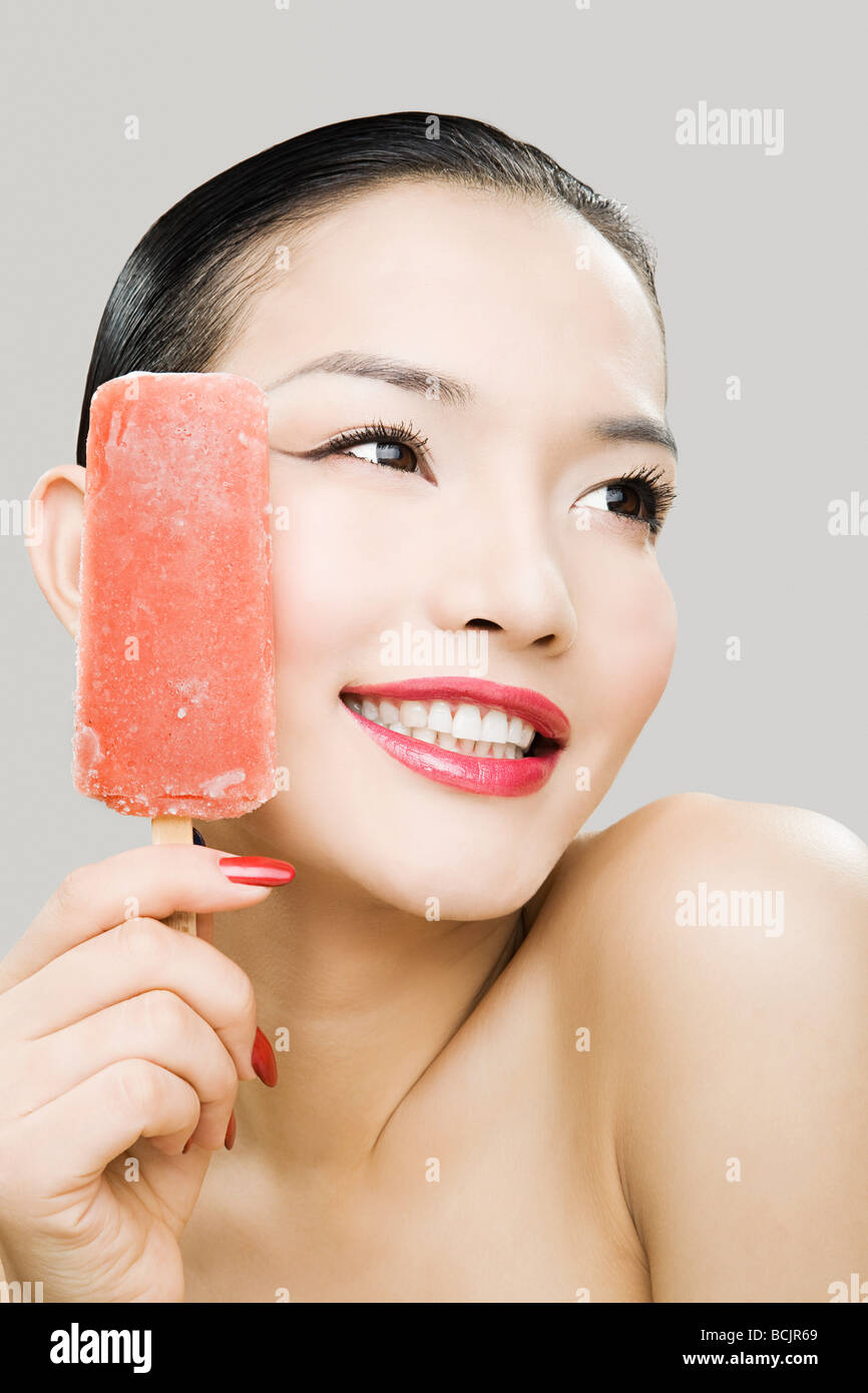 Young woman with ice lolly Stock Photo