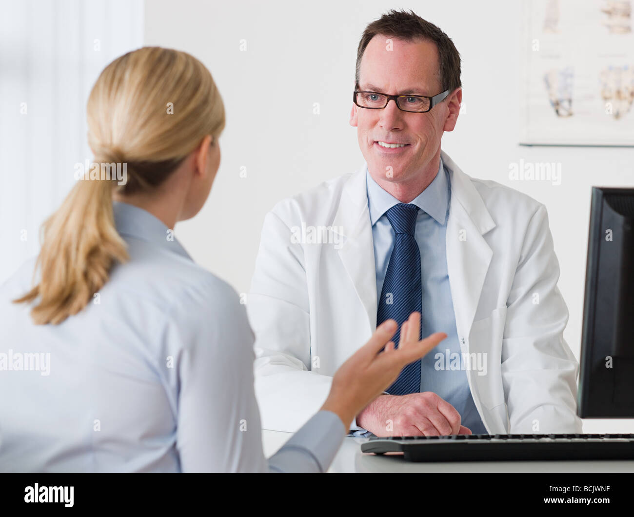 Woman talking to a doctor Stock Photo