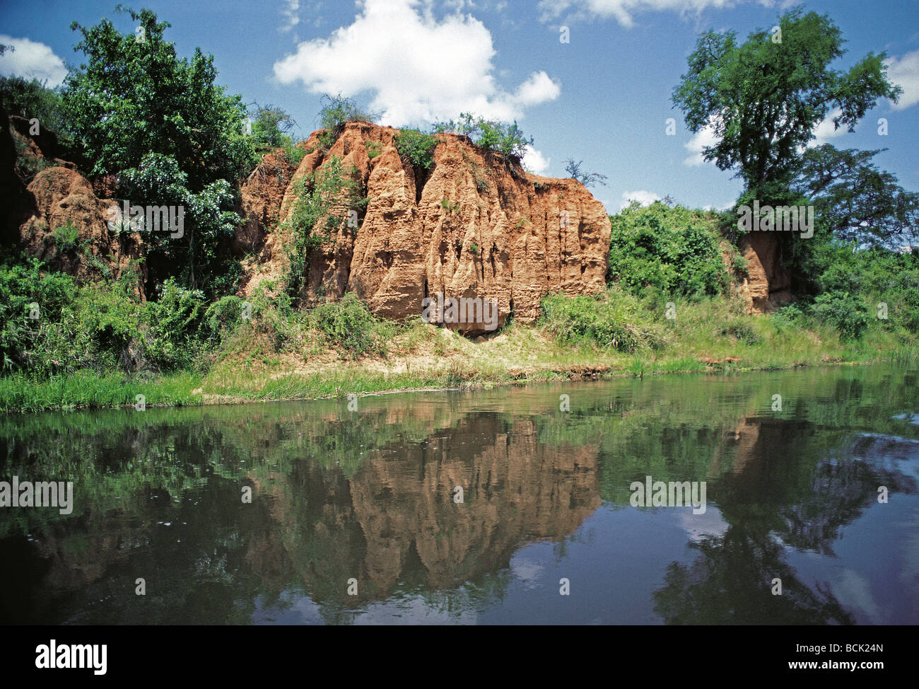 Eroded earth cliffs on northern bank of the River Nile seen from launch Murchison Falls National Park Uganda Africa Stock Photo
