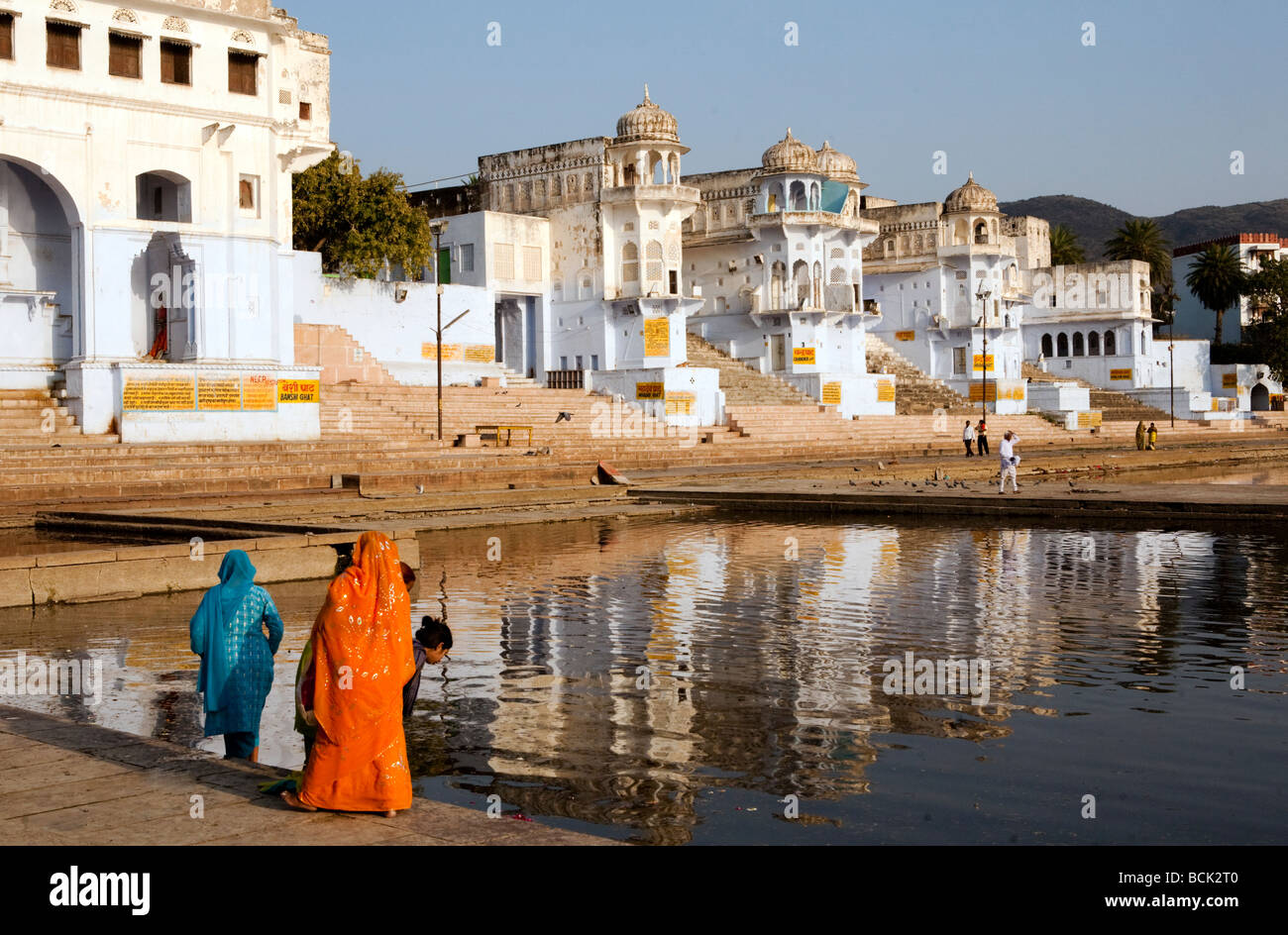 Indian Women In Colored Saris By The Holy Lake At Pushkar Rajasthan India Stock Photo