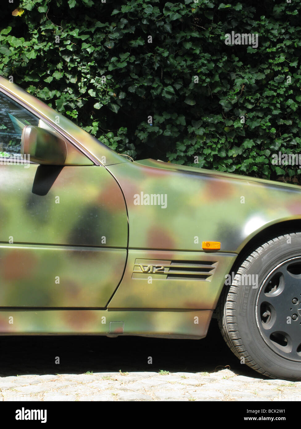 mercedes sports car painted with military army camouflage design Stock Photo