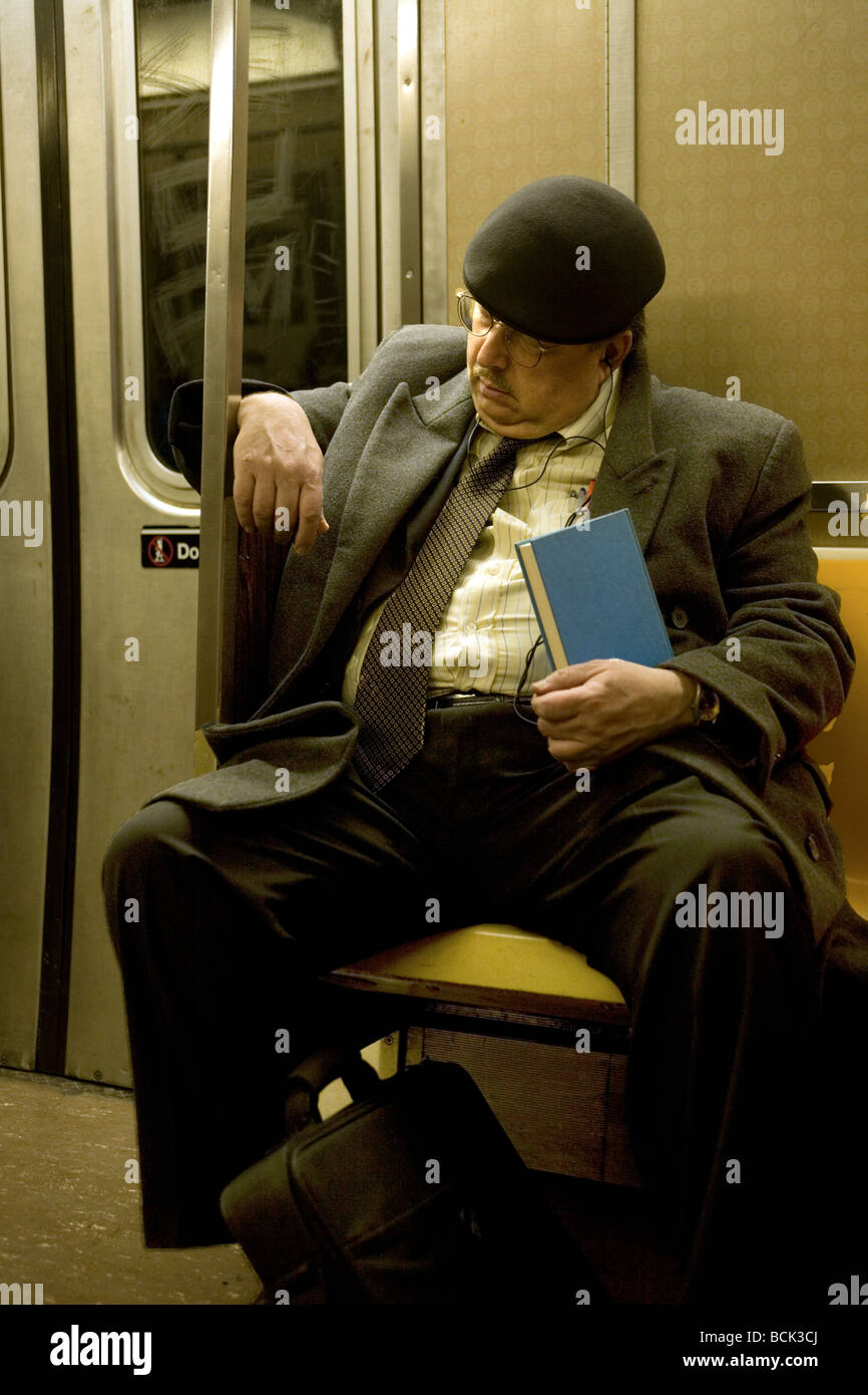 Tired man rides the subway home from work in New York City New York City NYC NY city urban urban life Manhattan Stock Photo