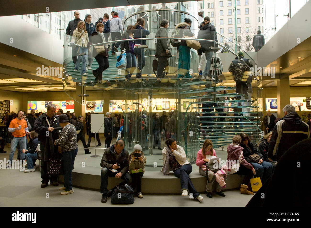 The popular Apple Computer store on 5th Ave. in NYC is always crowded with shoppers and tourists. Stock Photo