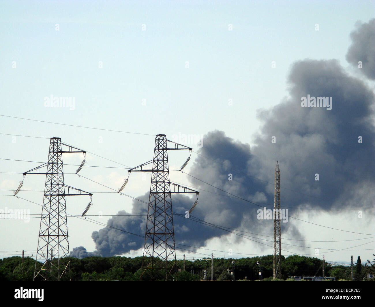 black smoke trail over rural green landscape with pylons Stock Photo ...