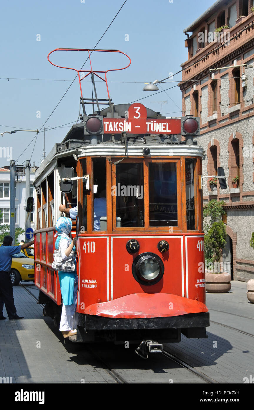 A Woman boarding the Antique Tram which runs between Tunel and Taksim Square in Istanbul Stock Photo