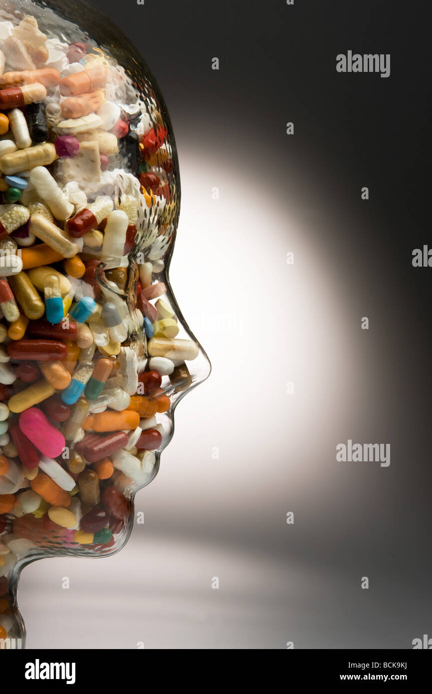 Tablets in head made of glass Stock Photo Alamy
