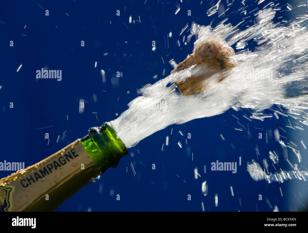 popping cork of an open champagne bottle Stock Photo