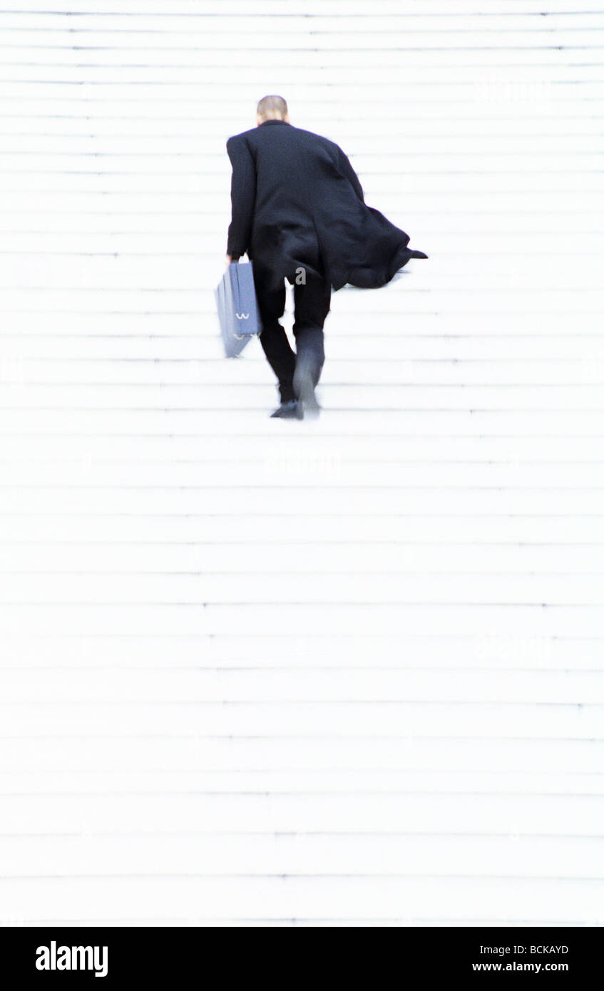 Businessman walking up steps, motion, full frame Stock Photo