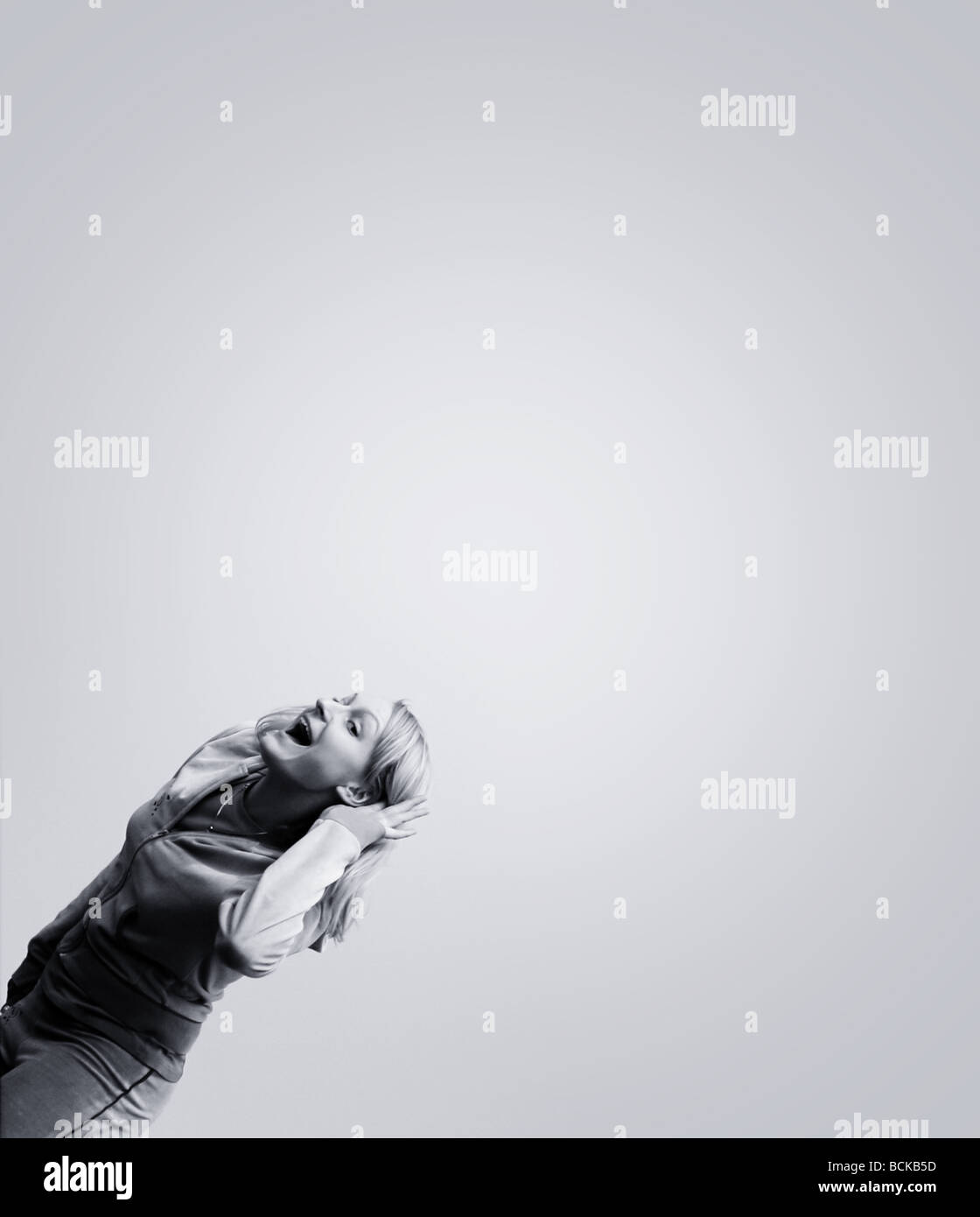 Happy woman against blue sky Stock Photo - Alamy