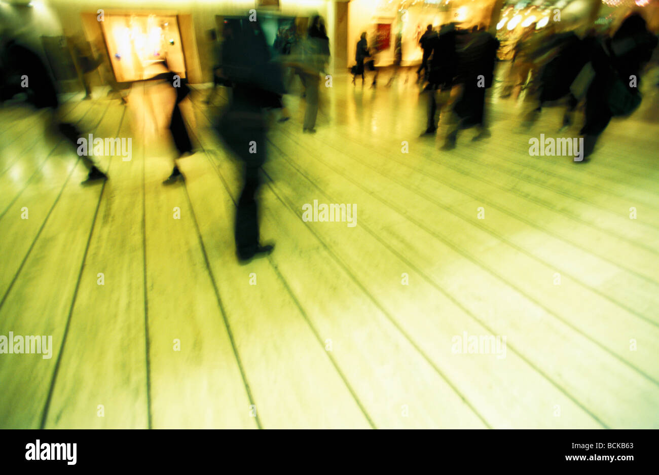 People walking through shopping center, blurred Stock Photo - Alamy