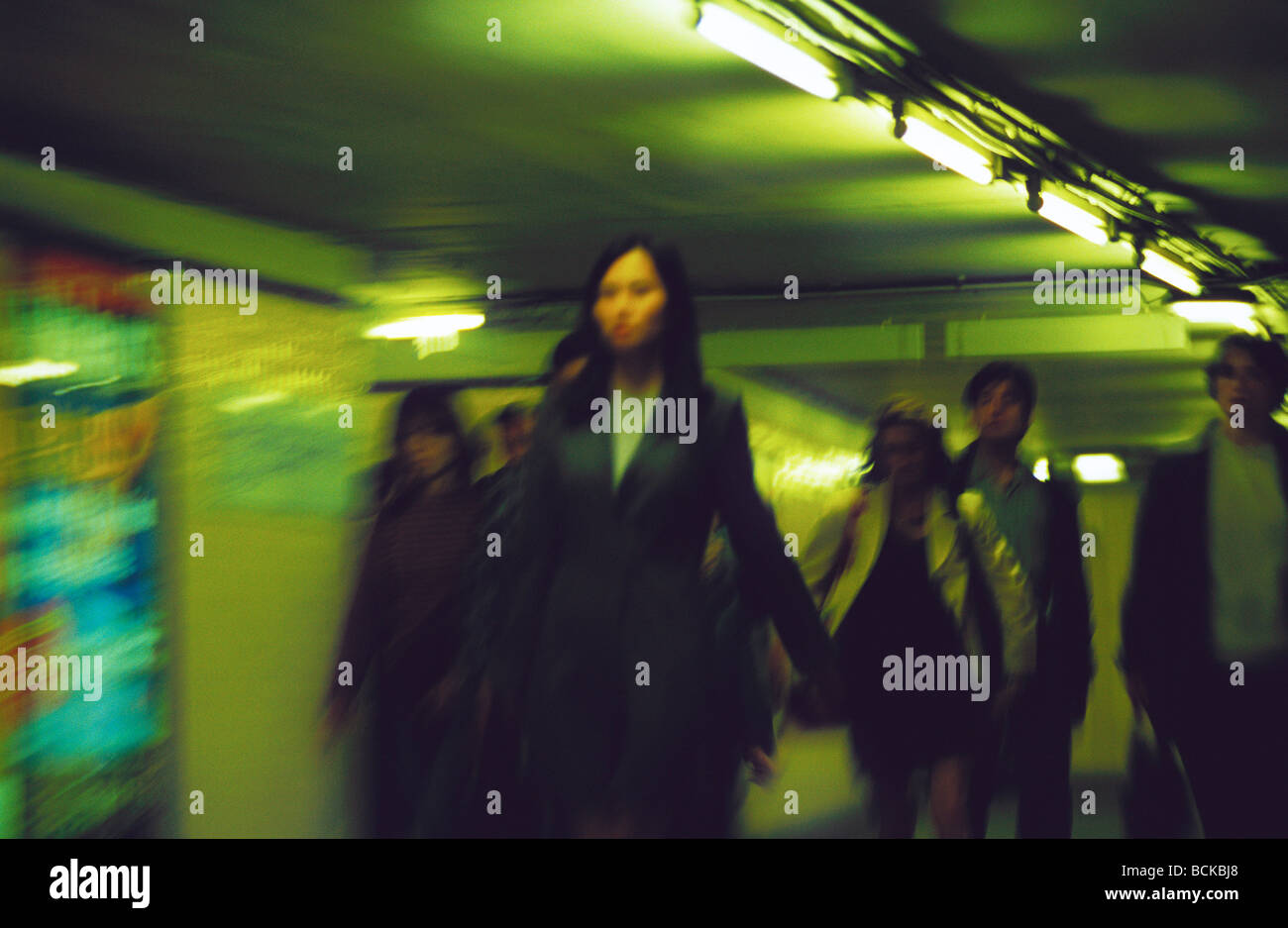 People walking through corridor, blurred Stock Photo - Alamy