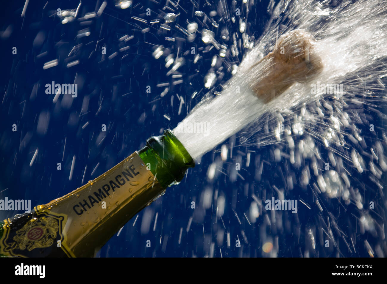 popping cork of an open champagne bottle Stock Photo Alamy