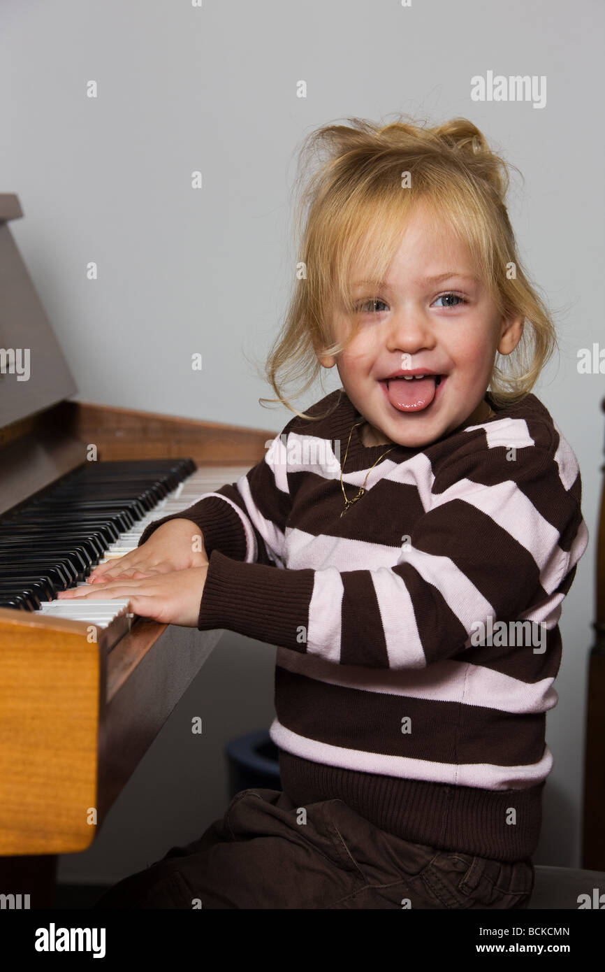 child plays on a piano Stock Photo