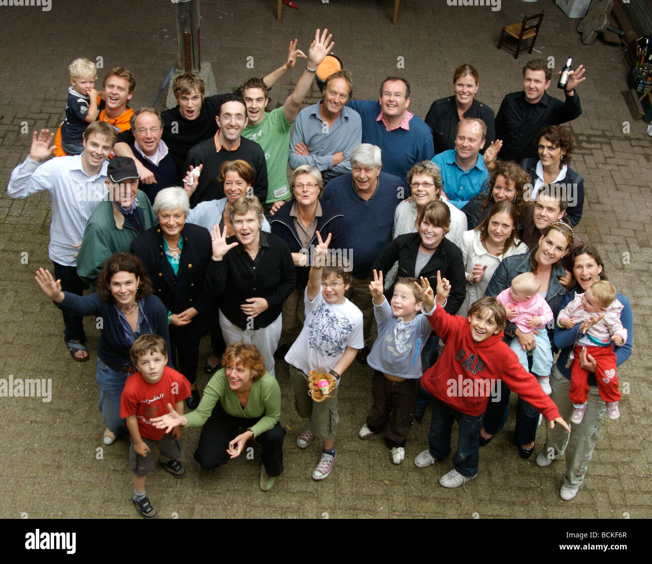 Large family group waving. Overhead view. Stock Photo