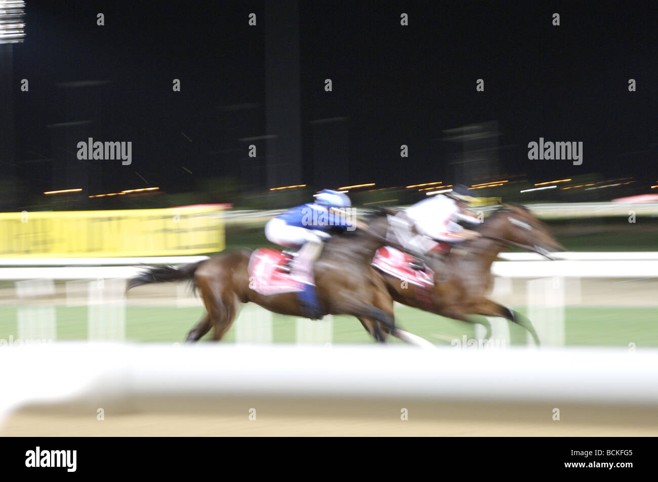 Blurred images of racehorses racing Stock Photo