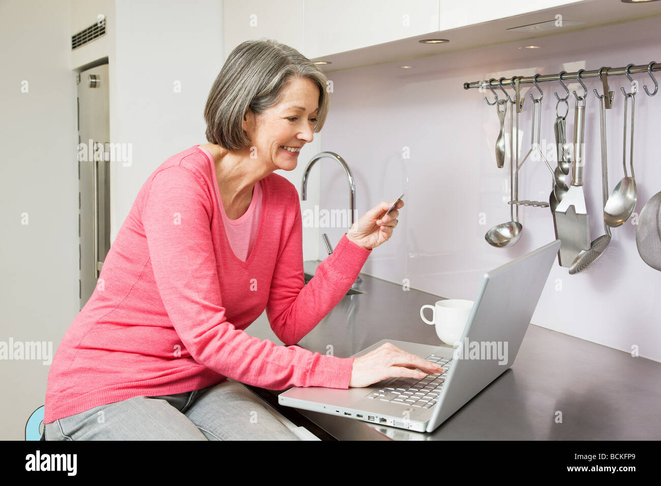 Mature woman using banking Stock Photo Alamy