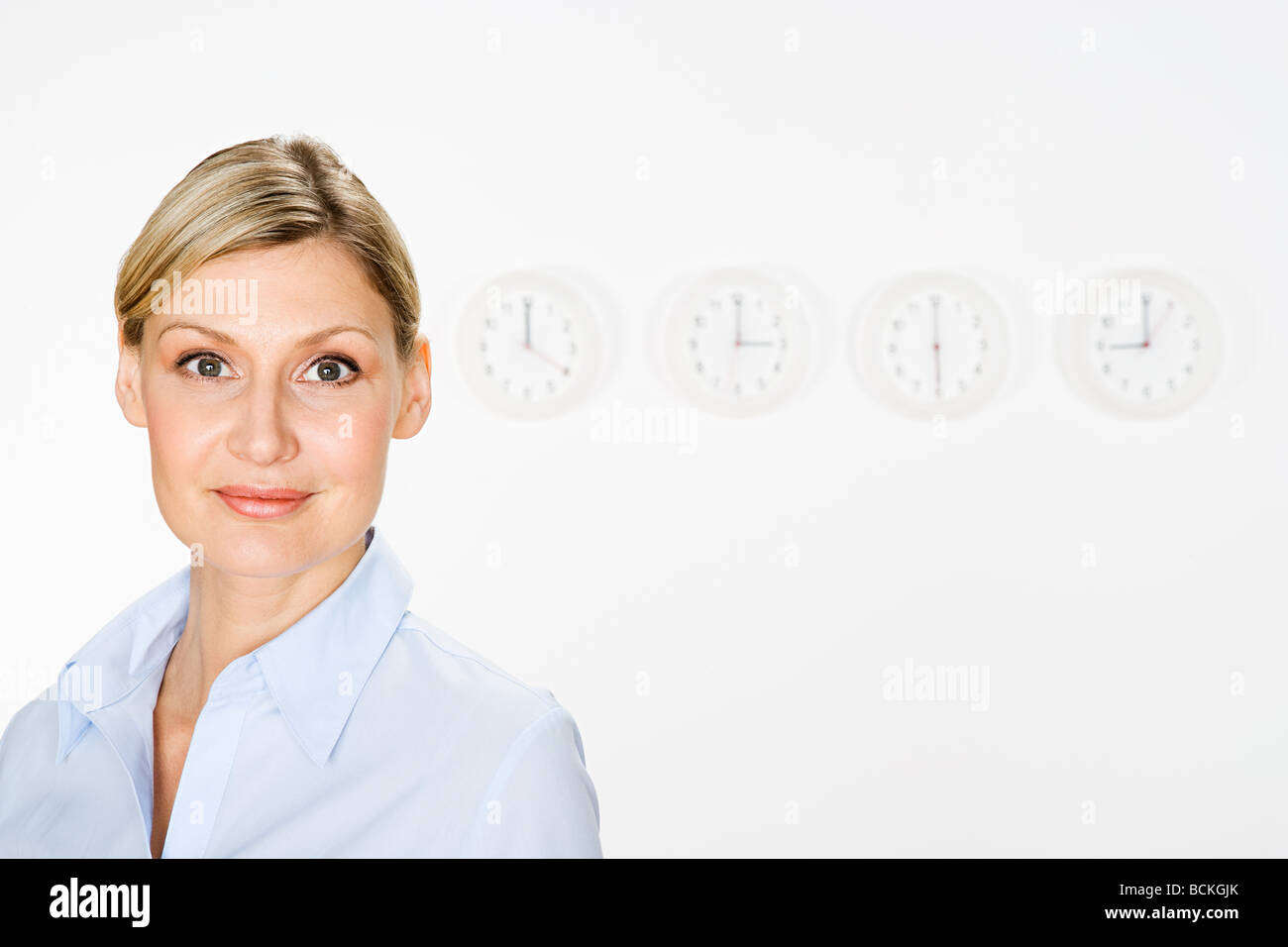 Businesswoman and clocks Stock Photo
