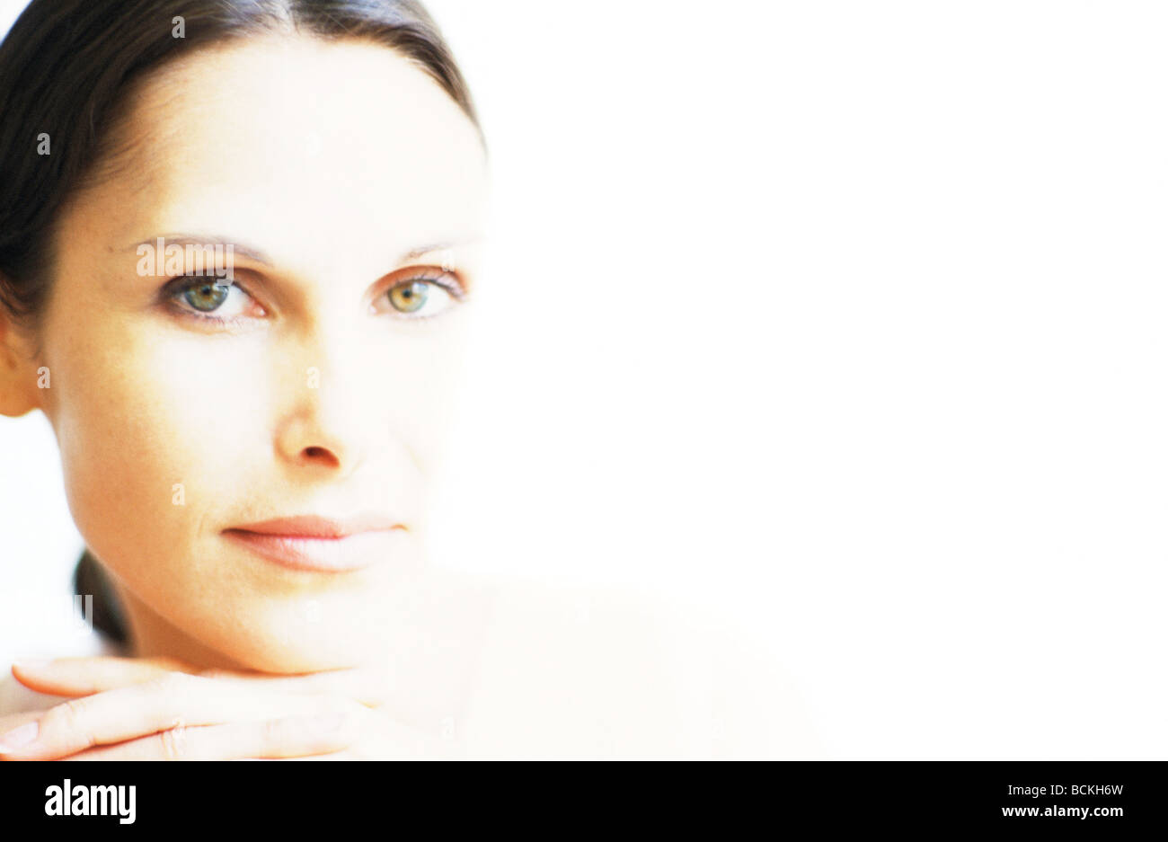 Woman eyes up finger on chin hi-res stock photography and images - Alamy