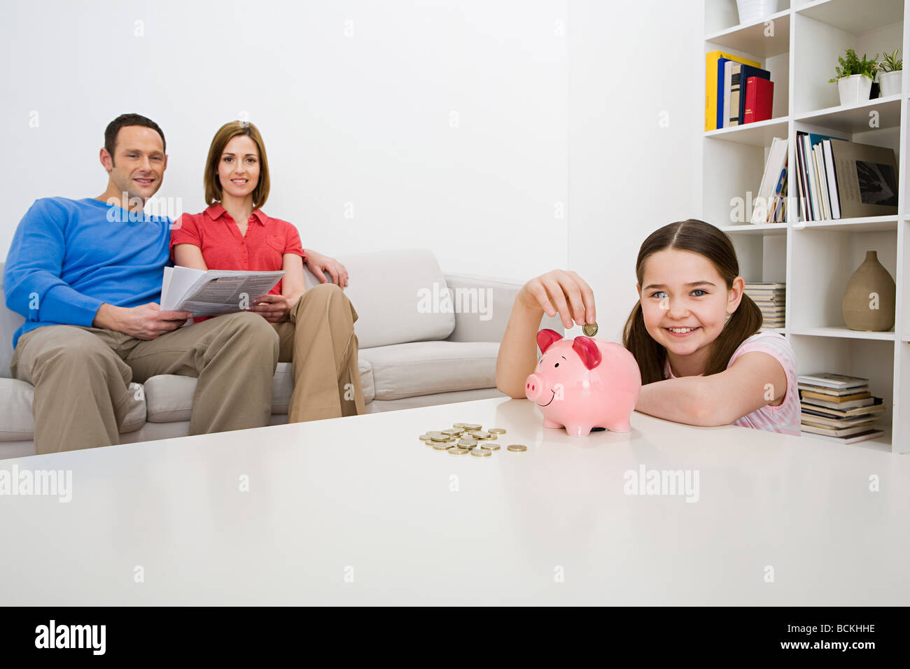 Family with piggy bank Stock Photo - Alamy