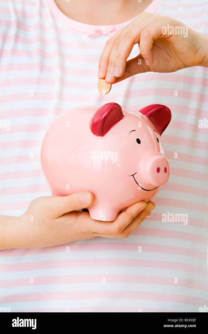 Young girl with piggy bank Stock Photo - Alamy