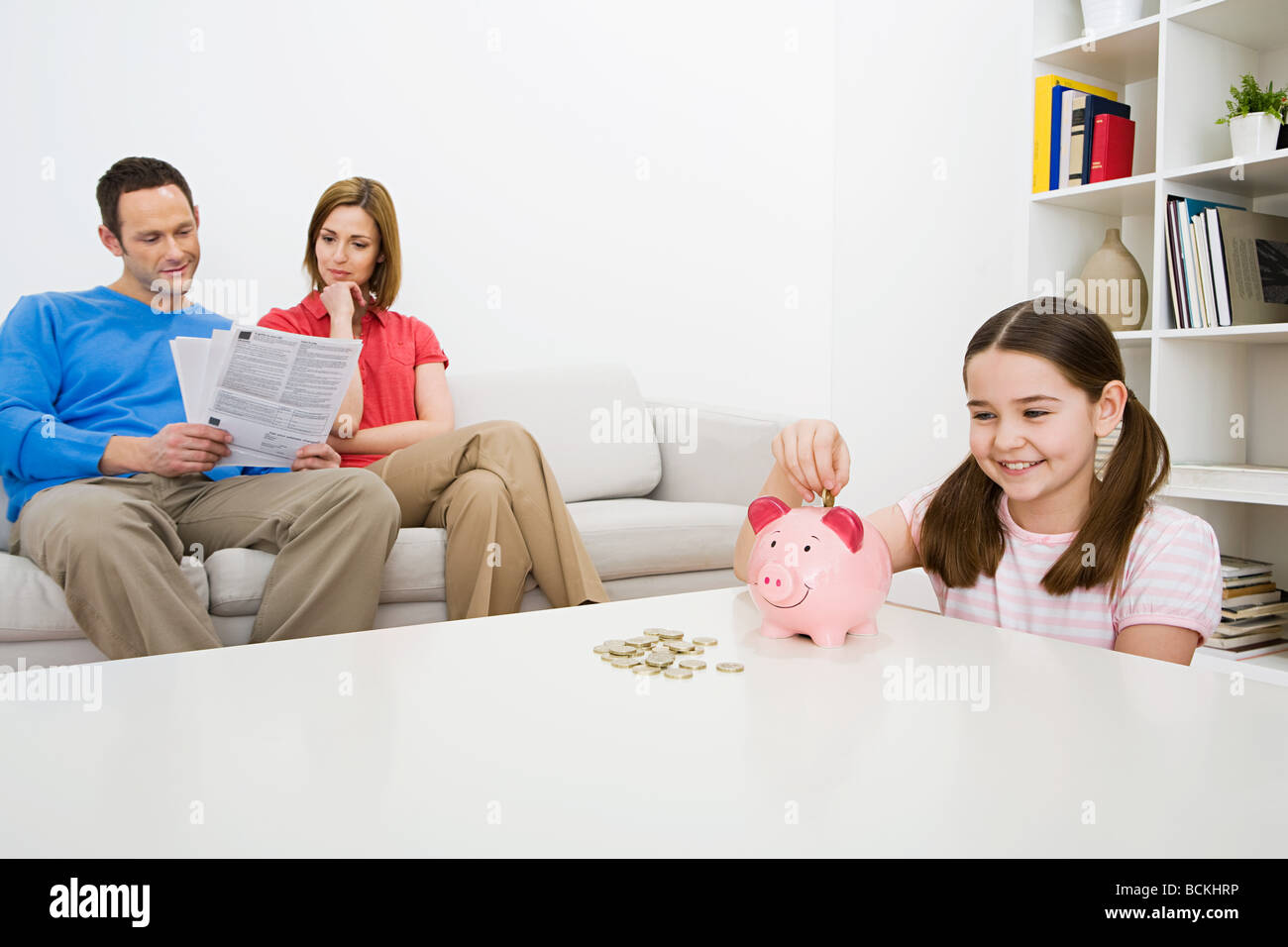 Family with piggy bank Stock Photo - Alamy
