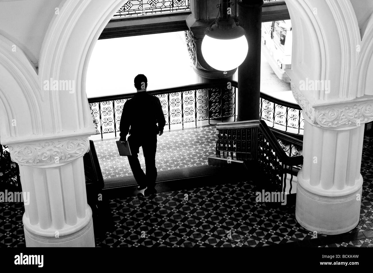 Man walking downstairs in QVB Queen Victoria Building Sydney NSW Australia Stock Photo