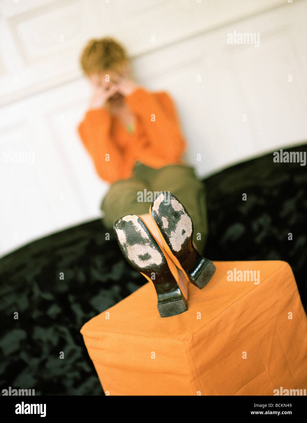 Woman sitting with feet up Stock Photo