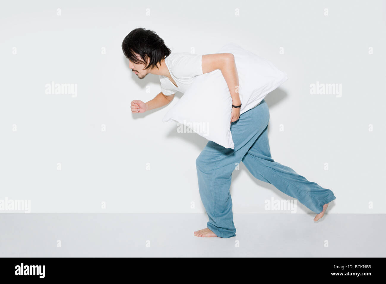 Man running with pillow Stock Photo Alamy