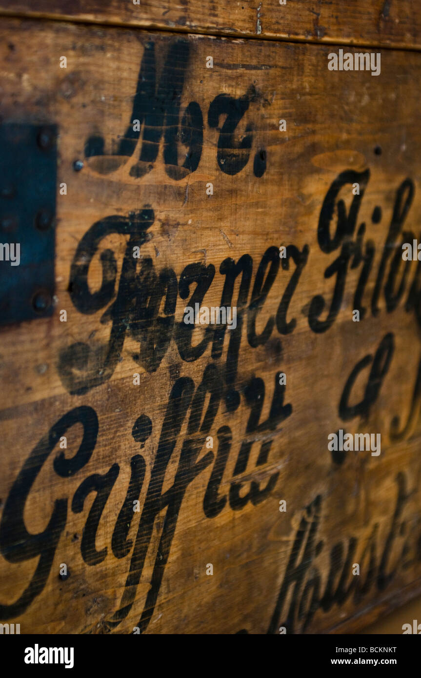 Old wooden immigrant trunk with the address written on it Broken Hill Migrant Museum Australia Stock Photo