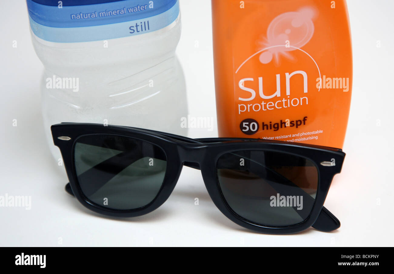 Hot weather precautions - sunblock, water, sunglasses Stock Photo