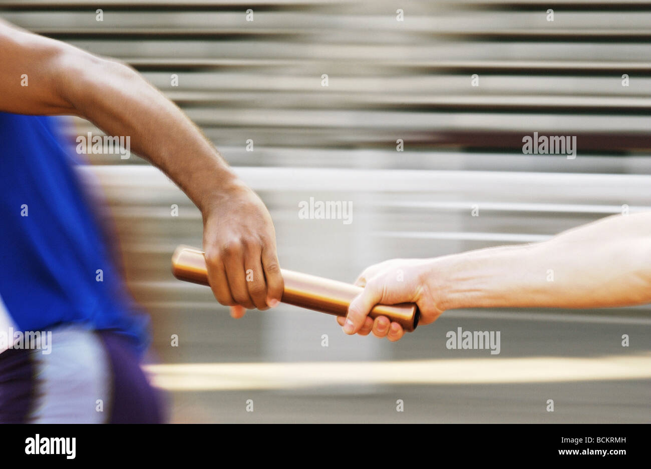 Athletes passing relay baton Stock Photo Alamy