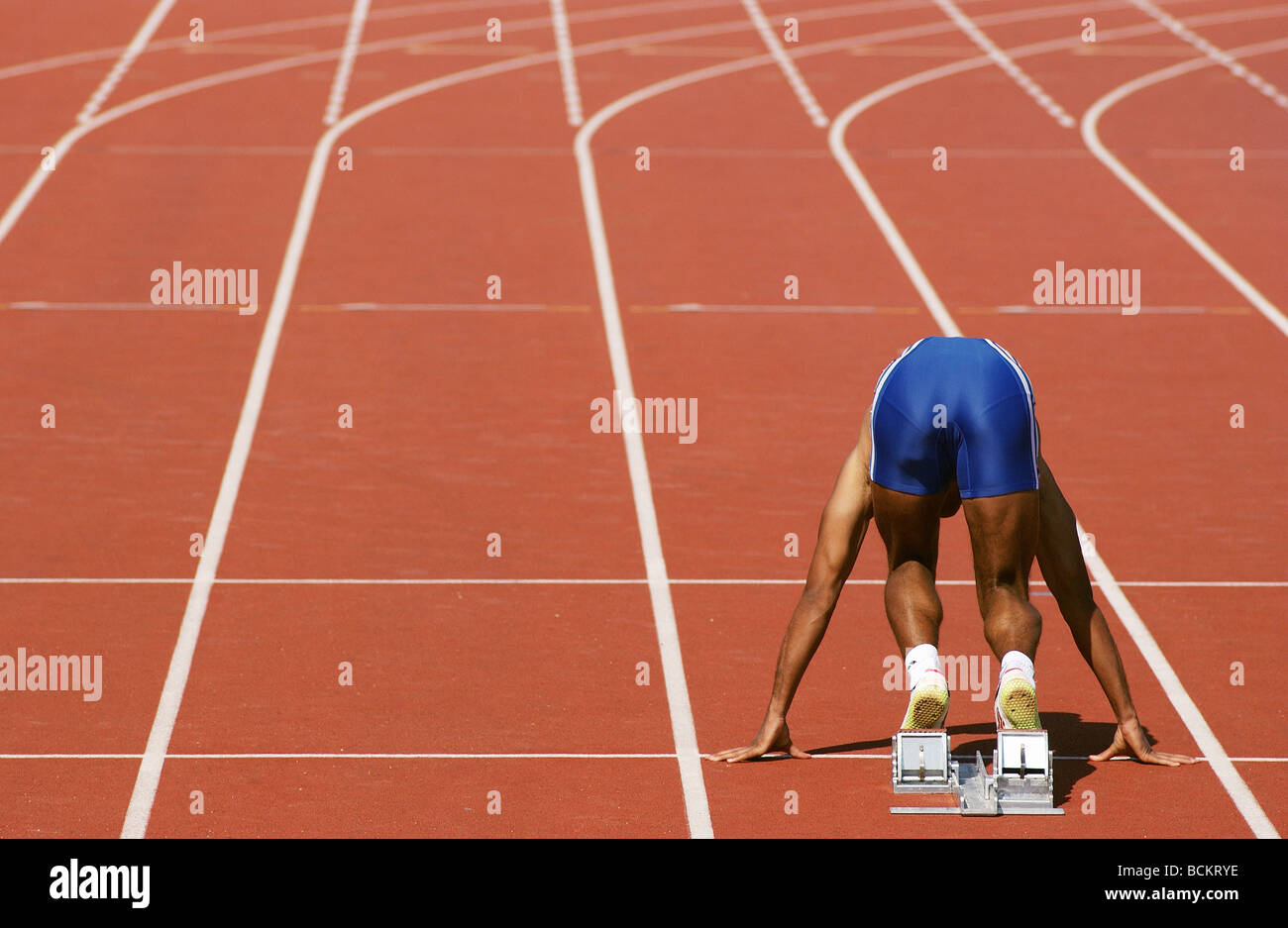 Runner at starting block, rear view Stock Photo Alamy