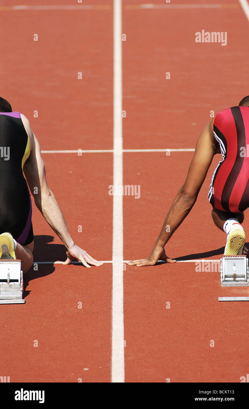 Runners at starting blocks, rear view Stock Photo Alamy