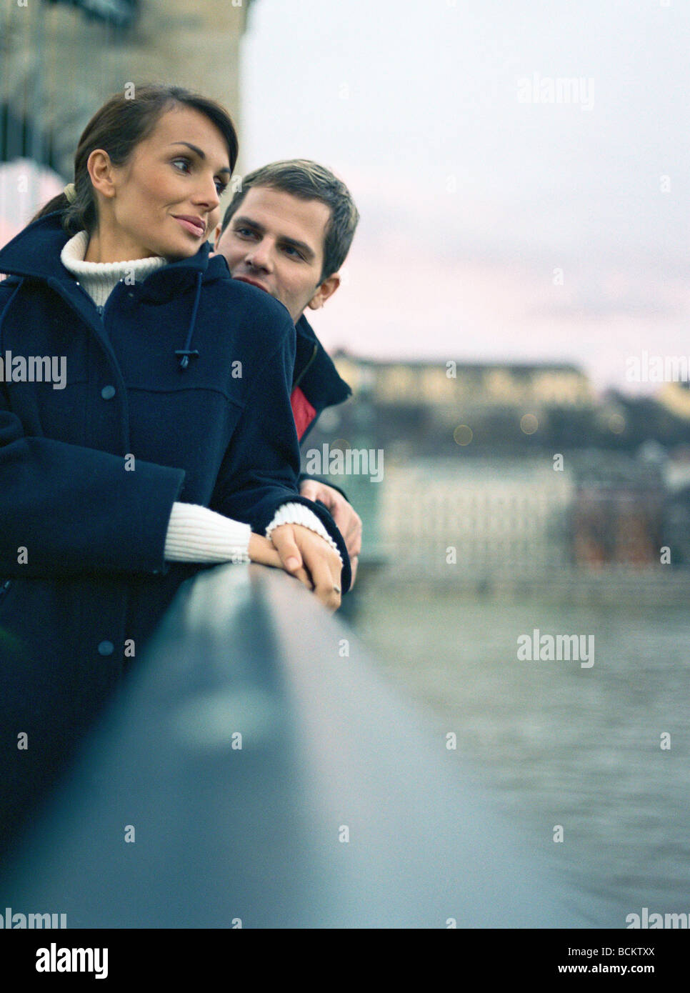 Man and woman standing together on bridge Stock Photo - Alamy