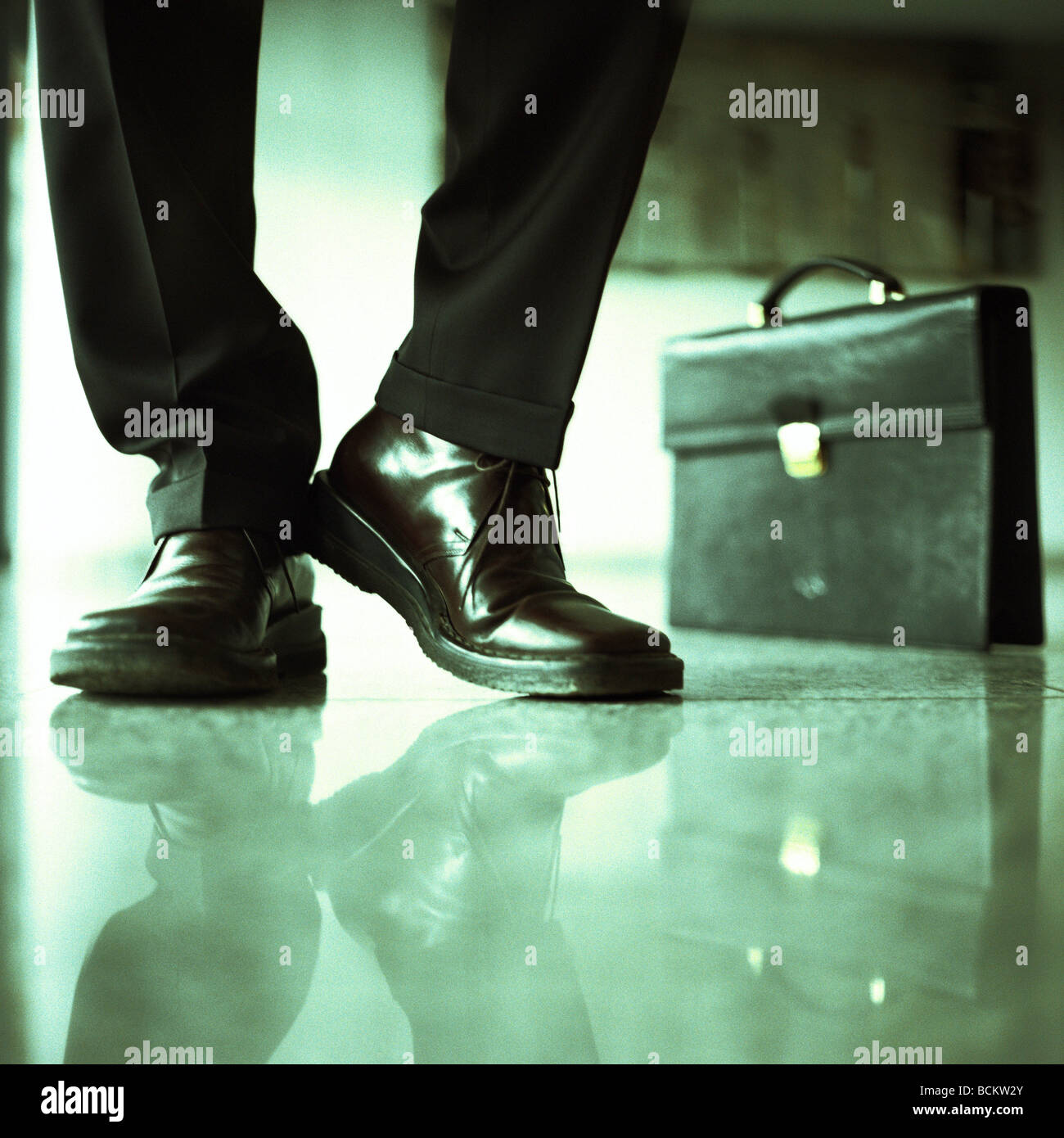 Businessman's lower legs and briefcase Stock Photo
