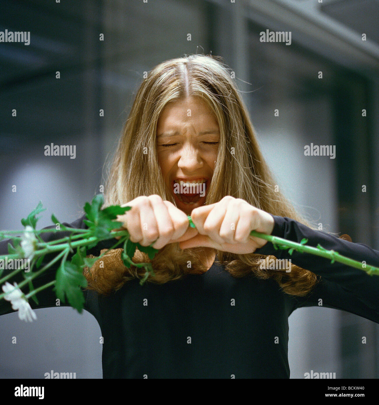 Woman holding out flowers, screaming Stock Photo - Alamy