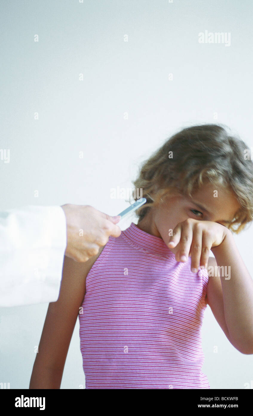 Doctor holding down tongue hires stock photography and images Alamy