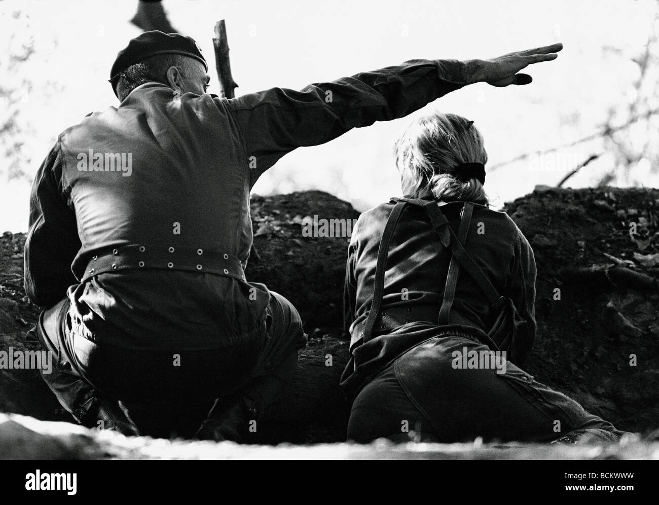 Soldiers in trench, one motioning with hand, b&w Stock Photo