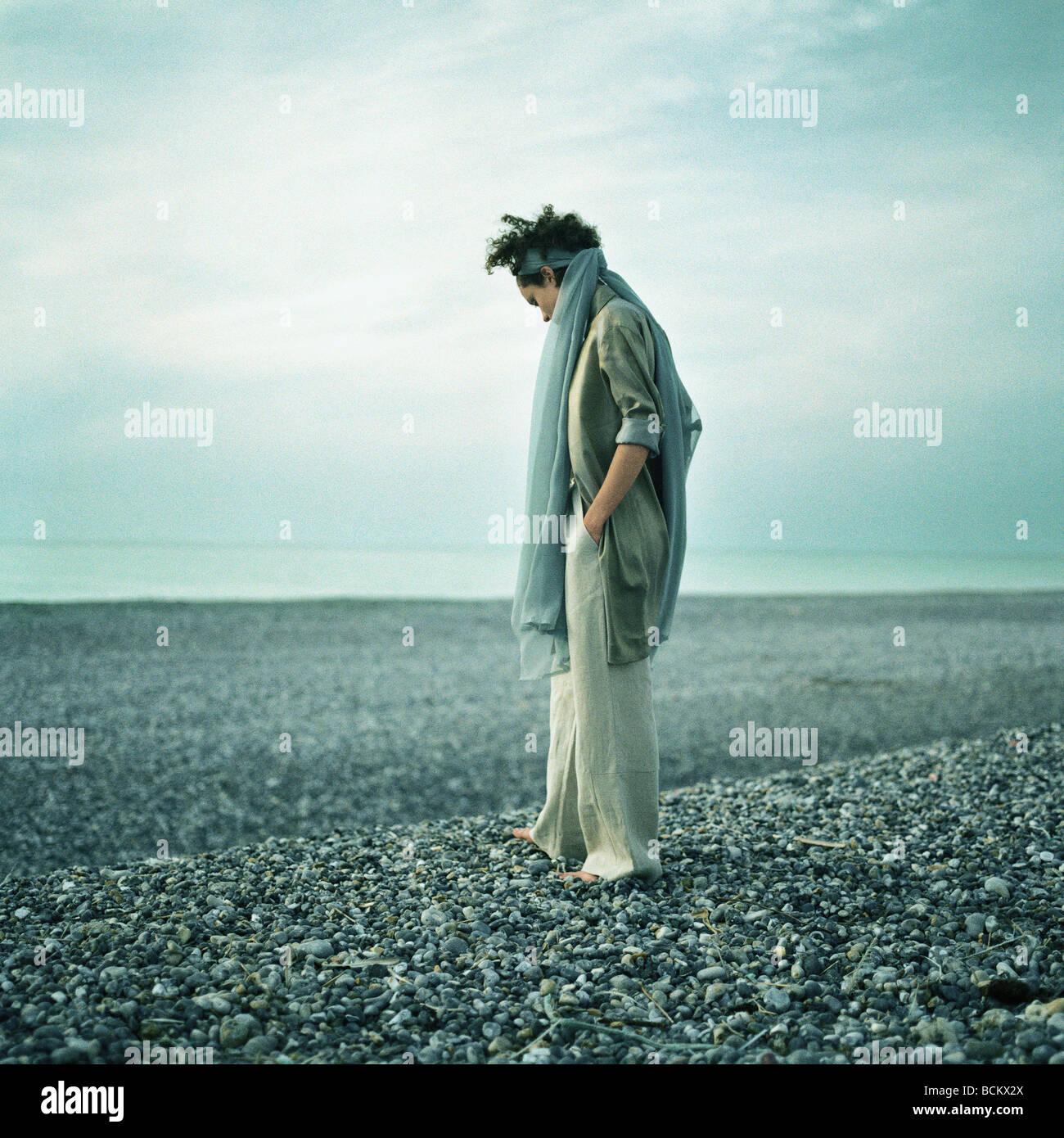 Woman in profile alone on beach hi-res stock photography and images - Alamy
