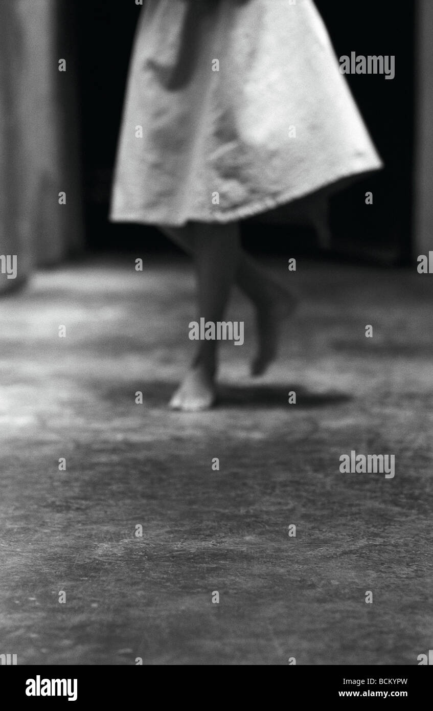 Woman walking barefoot on concrete, lower section, b&w Stock Photo