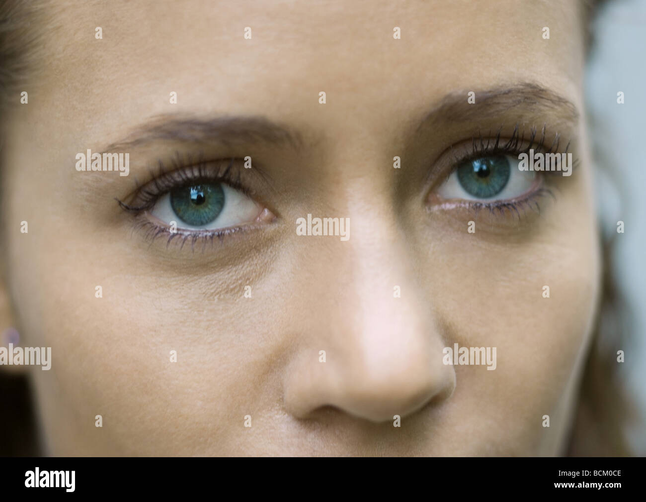 Woman's face, looking at camera, close-up, cropped view Stock Photo - Alamy