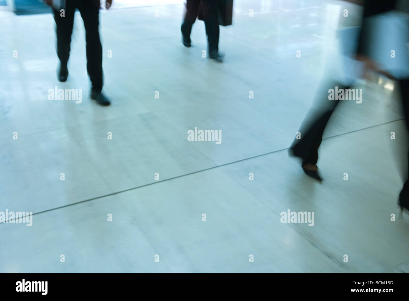 Business people walking, low section, blurred motion Stock Photo